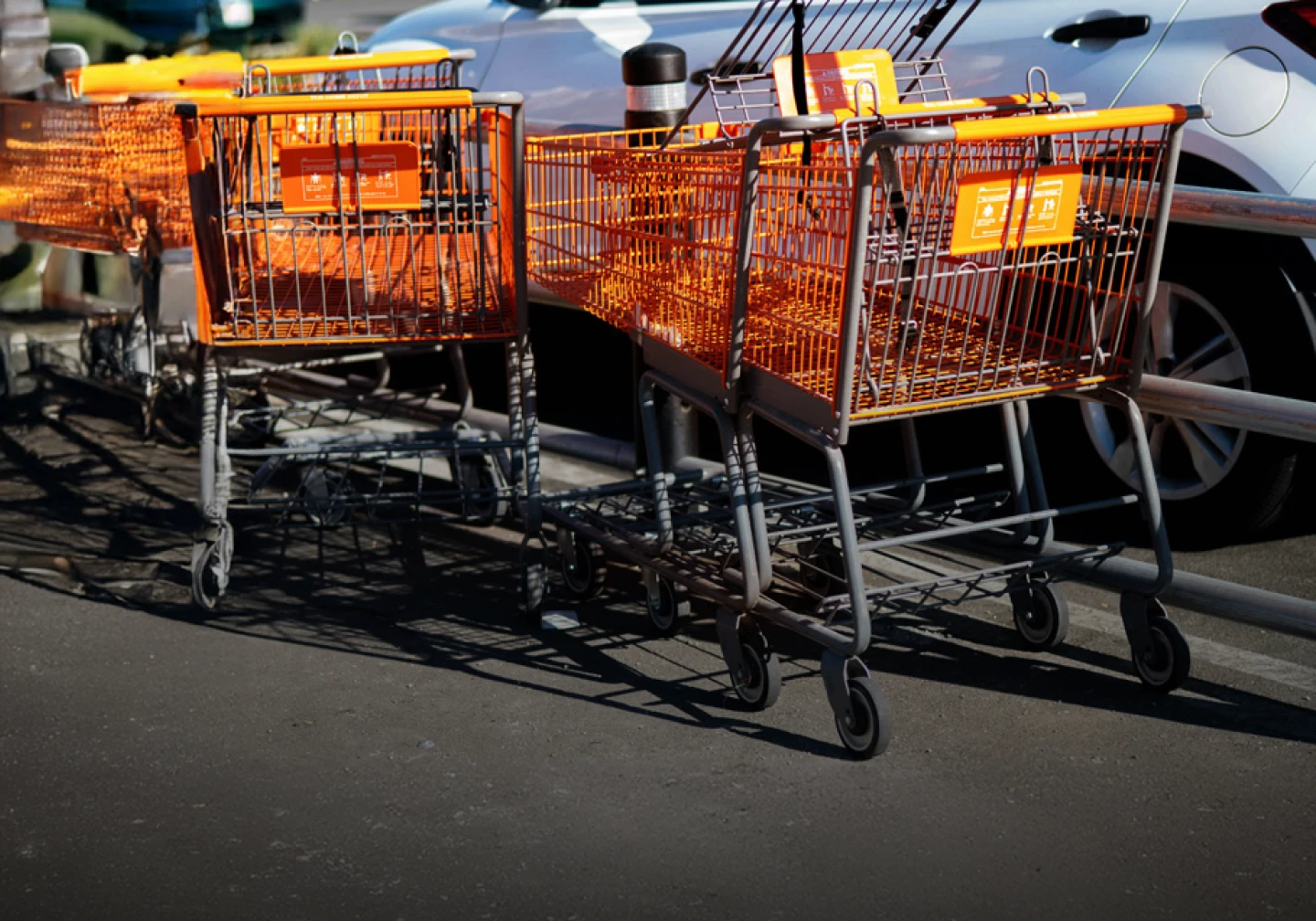  Empty shopping carts in return bay within parking lot.